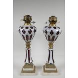 A pair of Bohemian style ruby glass oil lamps, with brass & marble mounts. 20" high