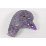 A C19th Amethyst crystal parasol handle, carved as a birds head, with red stone eyes. 2¼" long