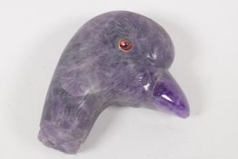 A C19th Amethyst crystal parasol handle, carved as a birds head, with red stone eyes. 2¼" long