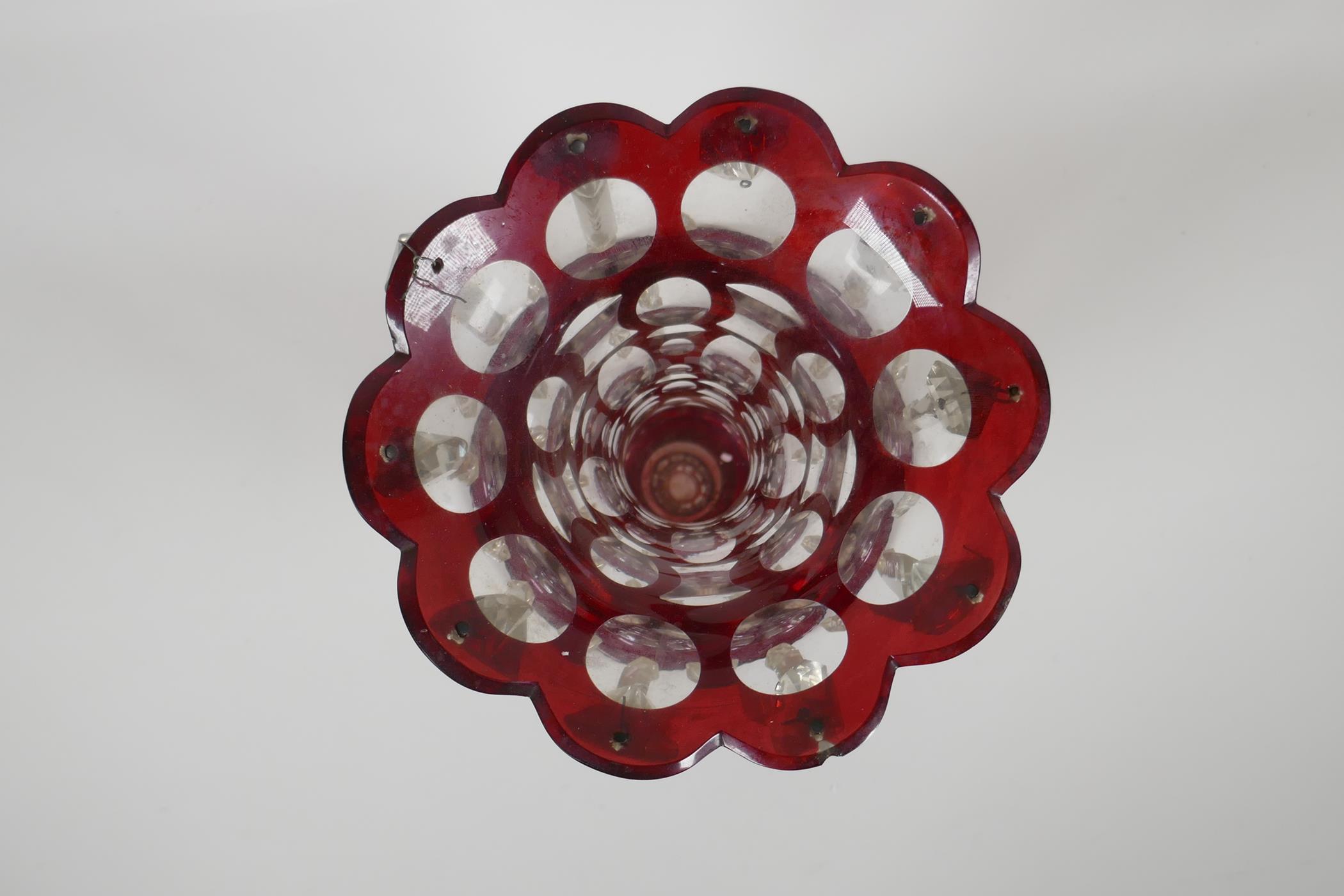 A Bohemian ruby glass lustre with slice cut decoration, 1 lustre missing, 12½" high - Image 2 of 3