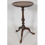 A mahogany wine table, with circular top on turned and carved column. With tripod base. 21" high x