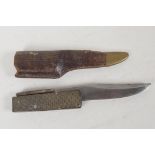 A late C19th/early C20th folding Bowie knife, with chequer horn handle and brass tipped leather