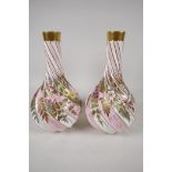 A pair of European porcelain vases, with spiralled bases, hand painted with flowers and raised