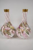 A pair of European porcelain vases, with spiralled bases, hand painted with flowers and raised