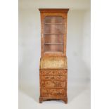 A small C19th walnut veneered bureau bookcase, the upper section with glazed door, adjustable