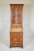 A small C19th walnut veneered bureau bookcase, the upper section with glazed door, adjustable