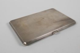 An engine turned hallmarked silver cigarette case by Charles Parker & Co Ltd, London, 1939, 182g, 5"