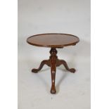 Georgian mahogany tilt top table with dished top, raised on a turned column and tripod supports with