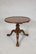 Georgian mahogany tilt top table with dished top, raised on a turned column and tripod supports with