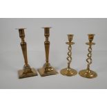 A pair of brass candlesticks with pierced spiral stems and another pair of candlesticks, largest 9½"