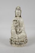 A blanc de chine porcelain Quan Yin seated on a lotus flower throne, impressed marks verso, 10" high