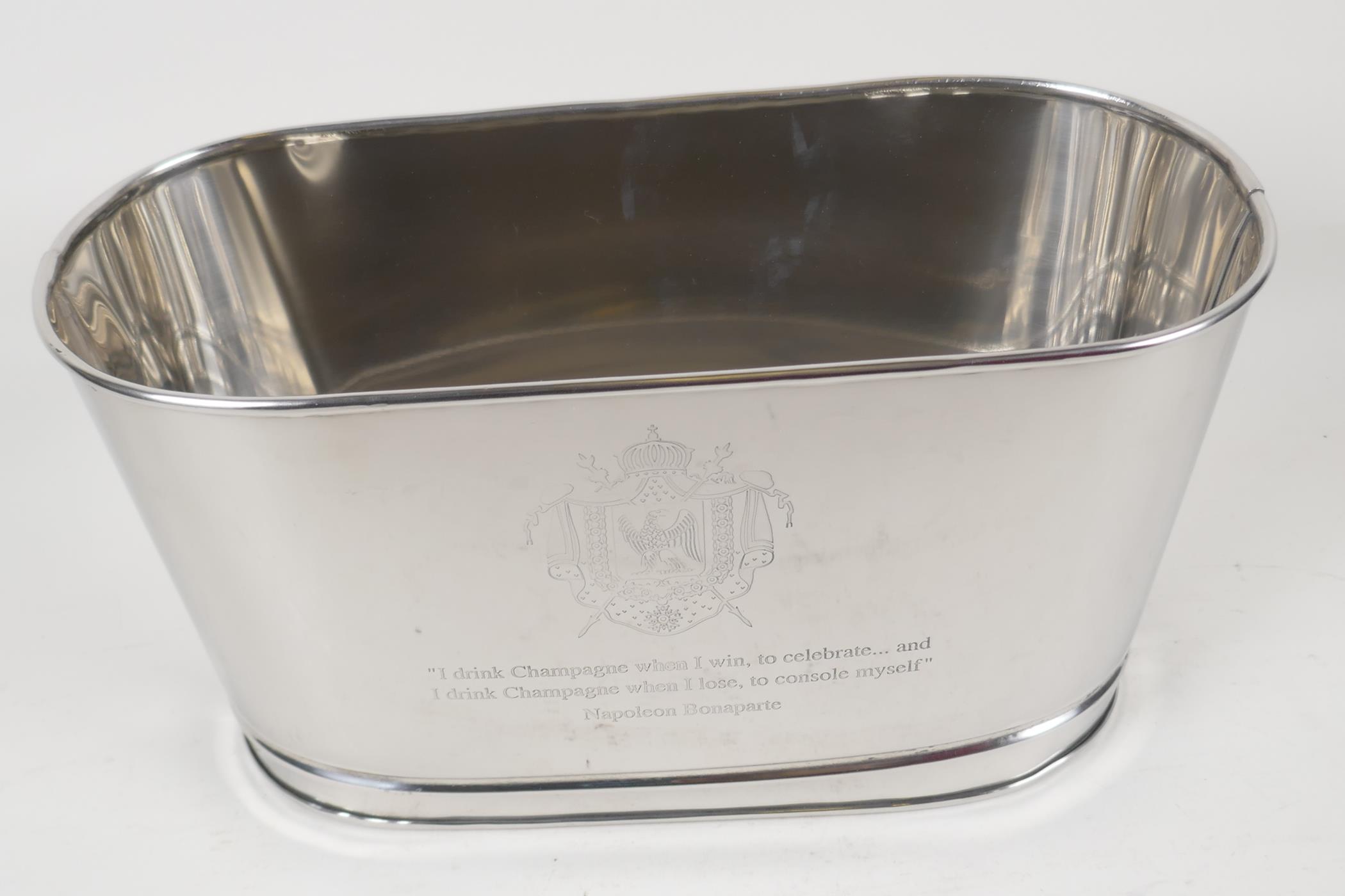 A plated metal wine cooler, engraved with aphorisms from Lily Bollinger & Napoleon. 11¾" long