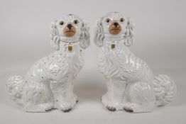 A pair of C19th white & gilt Staffordshire dogs, 12½" high