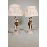 A pair of table lamps, in the form of classical figures. 32" high, with cream silk shades supplied