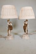 A pair of table lamps, in the form of classical figures. 32" high, with cream silk shades supplied