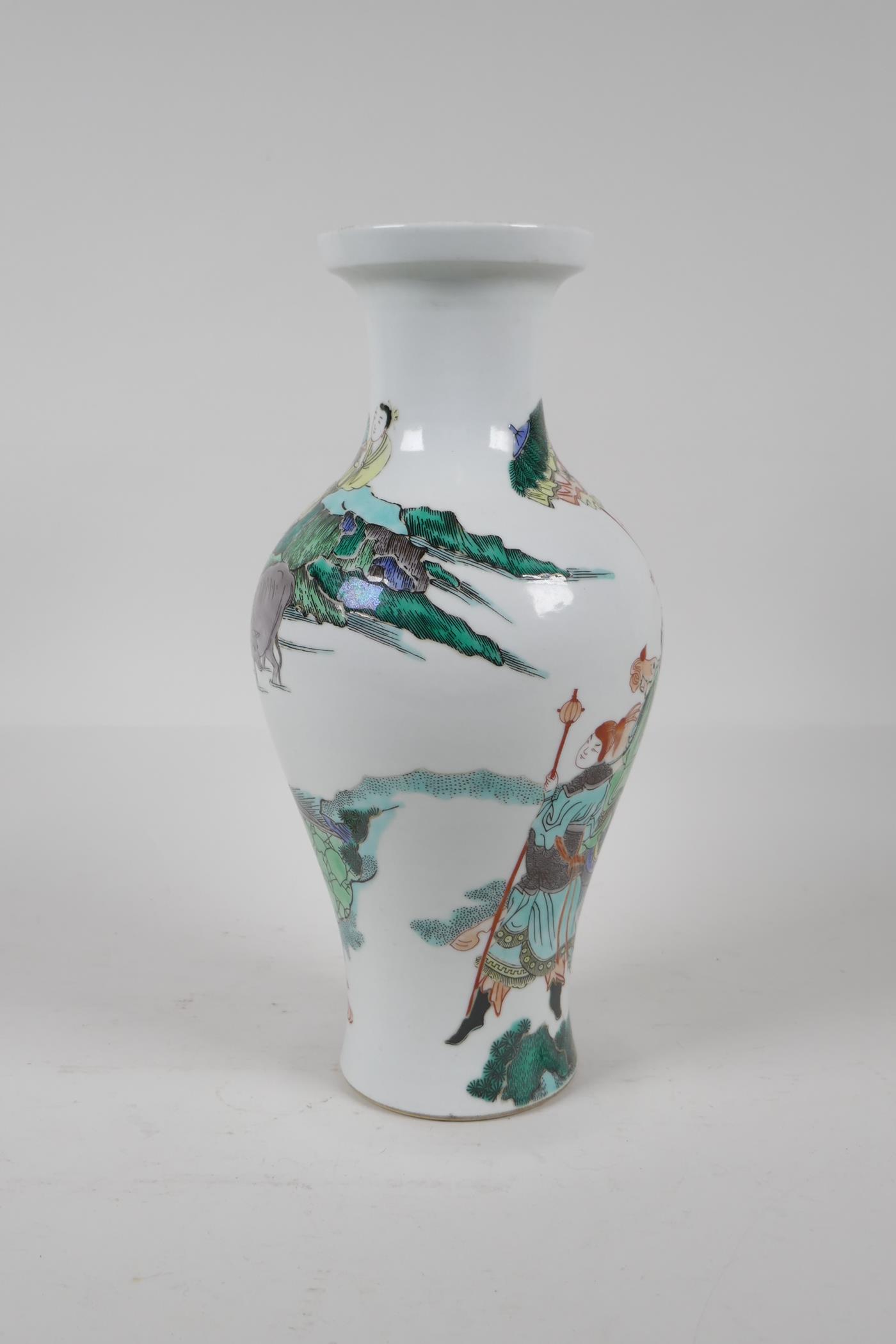 A Chinese Kangxi style famille verte porcelain vase decorated with travellers in a landscape, leaf - Image 2 of 5