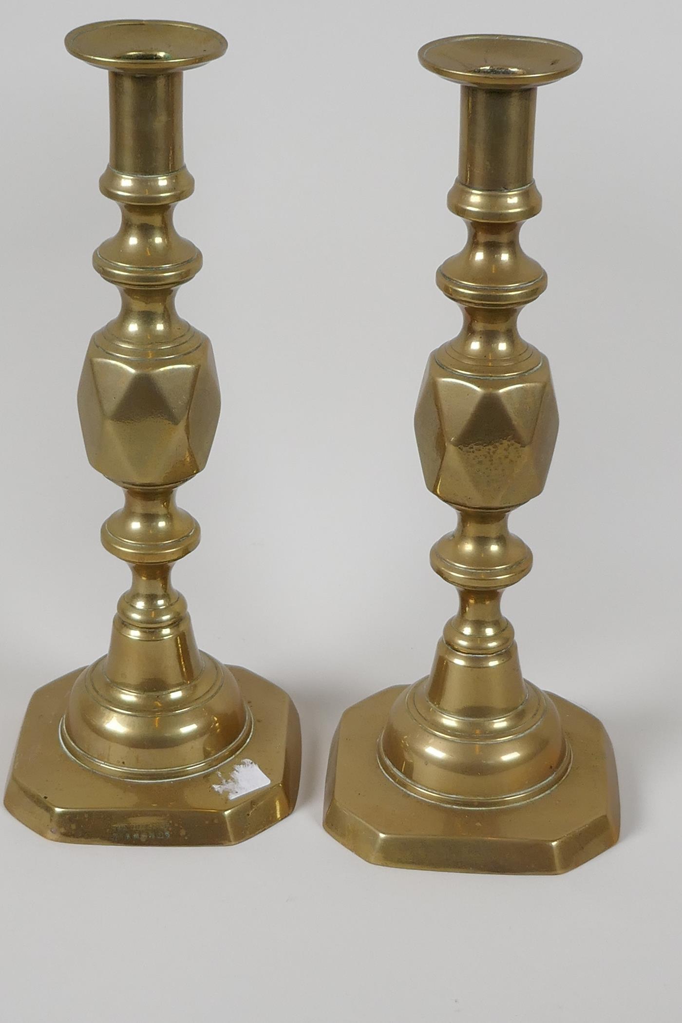 A pair of C19th brass "The Queen of Diamonds" pattern candlesticks, 11½" high