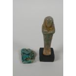 An Egyptian Faience pottery Shabti and a terracotta glazed amulet of Khum, largest 4" high