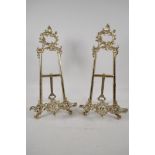 A pair of ornate cast brass easel stands, 16½" high