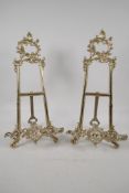 A pair of ornate cast brass easel stands, 16½" high