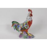 A brightly coloured porcelain figurine of a cockerel, 9" high