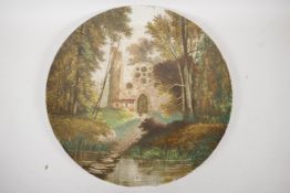 A large porcelain charger decorated with a figure in a wooded churchyard, 15" diameter