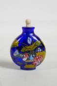 An enamelled blue Peking glass snuff bottle, decorated with waterfowl in a lotus pond, three