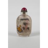 A Chinese reverse decorated glass snuff bottle, depicting bamboo & flowers in bloom, 3½" high