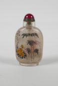 A Chinese reverse decorated glass snuff bottle, depicting bamboo & flowers in bloom, 3½" high