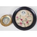 A 1920s embroidered mount with a picture of the Princess Elizabeth in a circular ebonised frame, 7½"