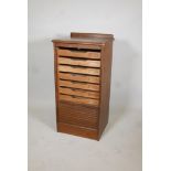 A 1930's oak tambour front multi drawer filing cabinet. 37" x 19" x 16"