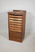 A 1930's oak tambour front multi drawer filing cabinet. 37" x 19" x 16"