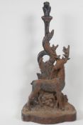 An C19th cast iron door stop, in the form of a stag by a tree