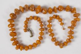 A string of 57 graduated natural amber beads, 20" long, 33g