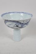 A Chinese blue & white porcelain stem cup, painted and embossed with dragons and clouds. 5" diameter