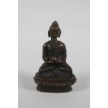 A Sino Tibetan bronze figure of buddha seated on a lotus throne, 3½" high