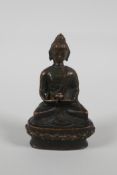 A Sino Tibetan bronze figure of buddha seated on a lotus throne, 3½" high