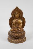 A Chinese filled gilt bronze of Quan Yin seated on a lotus throne, 4 character mark to base, 11"