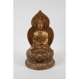 A Chinese filled gilt bronze of Quan Yin seated on a lotus throne, 4 character mark to base, 11"