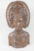 A Balinese carved hardwood bust, of a girl in ornate headdress, 15½" high