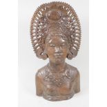 A Balinese carved hardwood bust, of a girl in ornate headdress, 15½" high