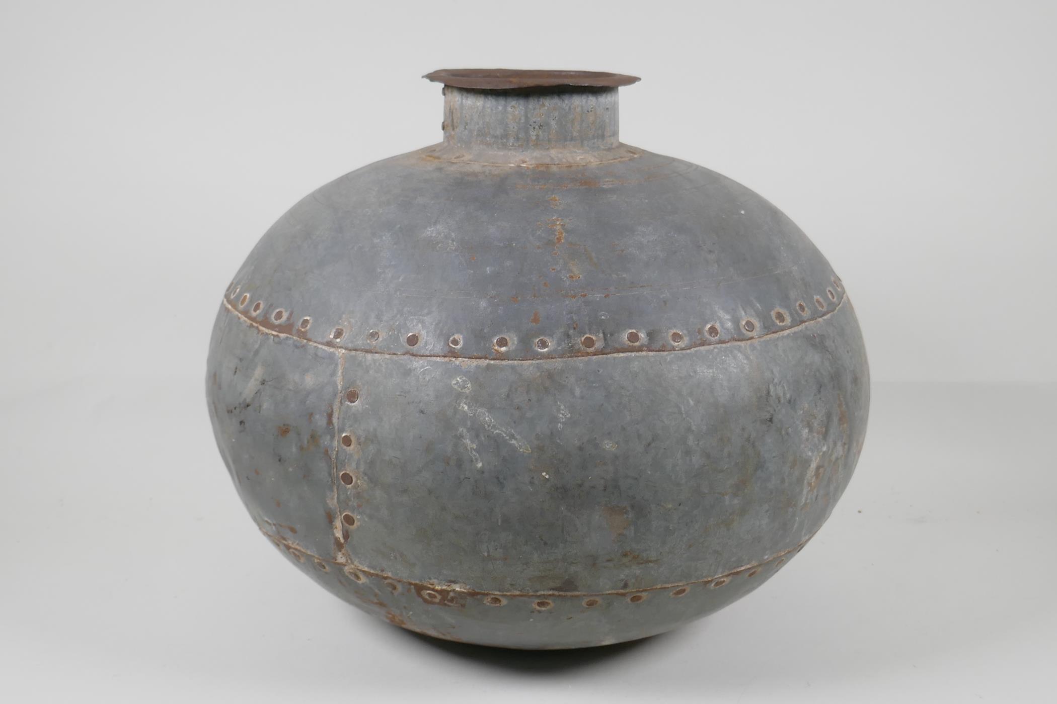 An Indian riveted metal pot/jar, 13½" diameter