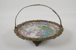 A C19th Canton enamel porcelain cabinet plate in a French ormilou basket mount, decorated with