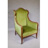 A Victorian mahogany wingback armchair with green upholstery
