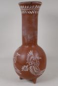 A Mexican terracotta of bulbous form, with long neck and flared rim. With scafito decoration of