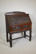 Chinese hardwood fall front bureau, with fitted interior over two frieze drawers, raised on four