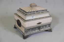 A C19th Vizagapatam ivory workbox, the shaped top opening to reveal an interior with fitted