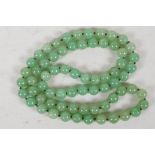 A Jade bead necklace, 34" long