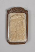 A Japanese carved wood and bone plaque, 2¾" long