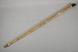 An oriental, faux bone sectional walking stick, with engraved decoration, AF, loss to handle &